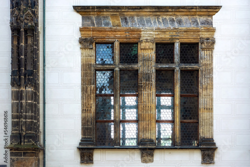 Rectangular window with a marble border and a marble column against a light wall. From the Window of the World series.