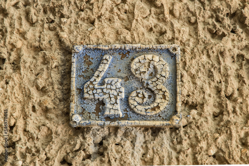 Old retro weathered cast iron plate number 43 closeup