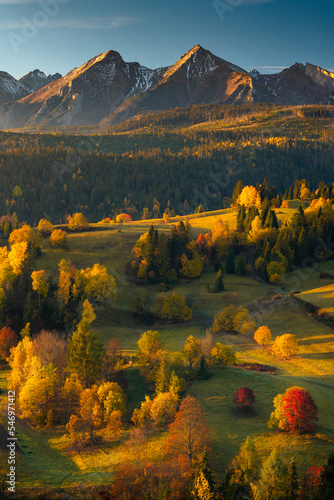 Fototapeta Naklejka Na Ścianę i Meble -  Autumn views near the village of Osturnia in Slovakia. Colorful trees harmonize beautifully with the Tatra Mountains in the background.