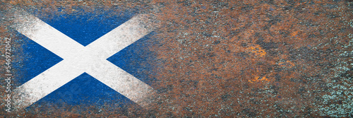 Flag of Scotland. Flag painted on rusty surface. Rusty background. Copy space. Textured creative background