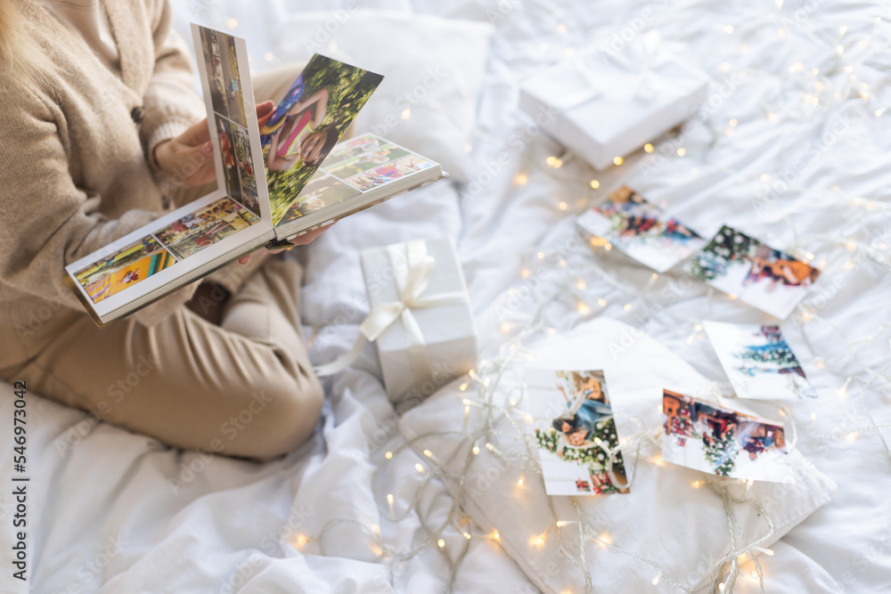 A portrait of woman viewing a photo album at christmas A portrait of woman viewing a photo album at christmas