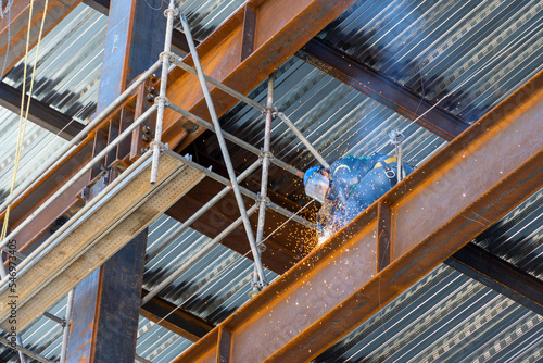 rusted steel structure while a man is welding joints, mexico guadalajara photo