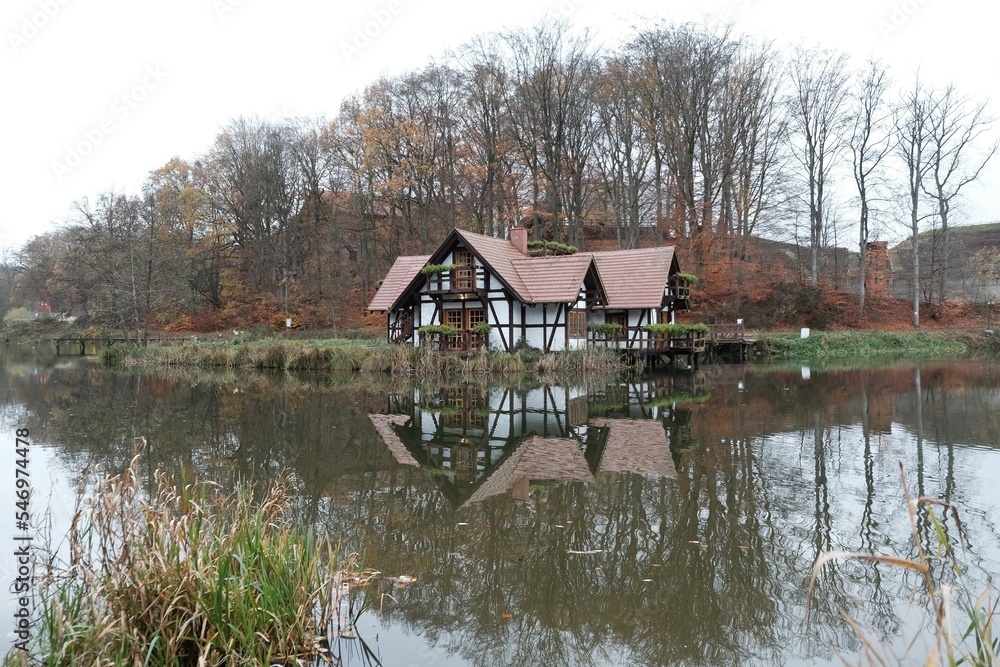 Fototapeta premium Houses on the water in Charlotta Valley near Ustka, Poland. Charlotta Valley is known for its Rock Legend Festival, performed here Santana, Plant, ZZ-Top