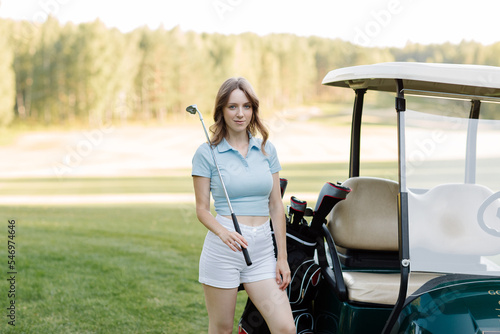 Portrait of a female golfer on the golf course. To play golf. High quality photo