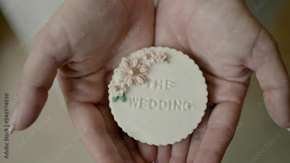 A bride opens her palms and shows a beautifully designed soap with flowers and pearls for a wedding day. Slow motion close-up. The perfect wedding day. A bride opens her palms and shows a beautifully designed soap with flowers and pearls for a wedding day. Slow motion close-up. The perfect wedding day.