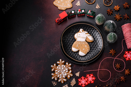Beautiful different Christmas decorations and gingerbread on a brown concrete table