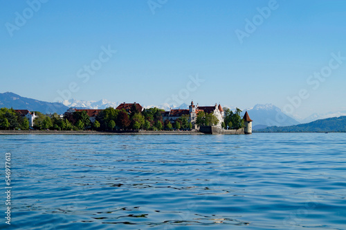 the beautiful island of Lindau on lake Constance (lake Bodensee) with the snowy Swiss Alps in the background, Germany on fine sunny spring day