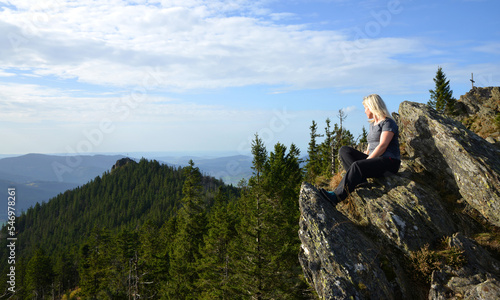Woman on the top of mountain Grosser Osser ( Velky Ostry ) in the National park Bayerischer Wald, Germany.