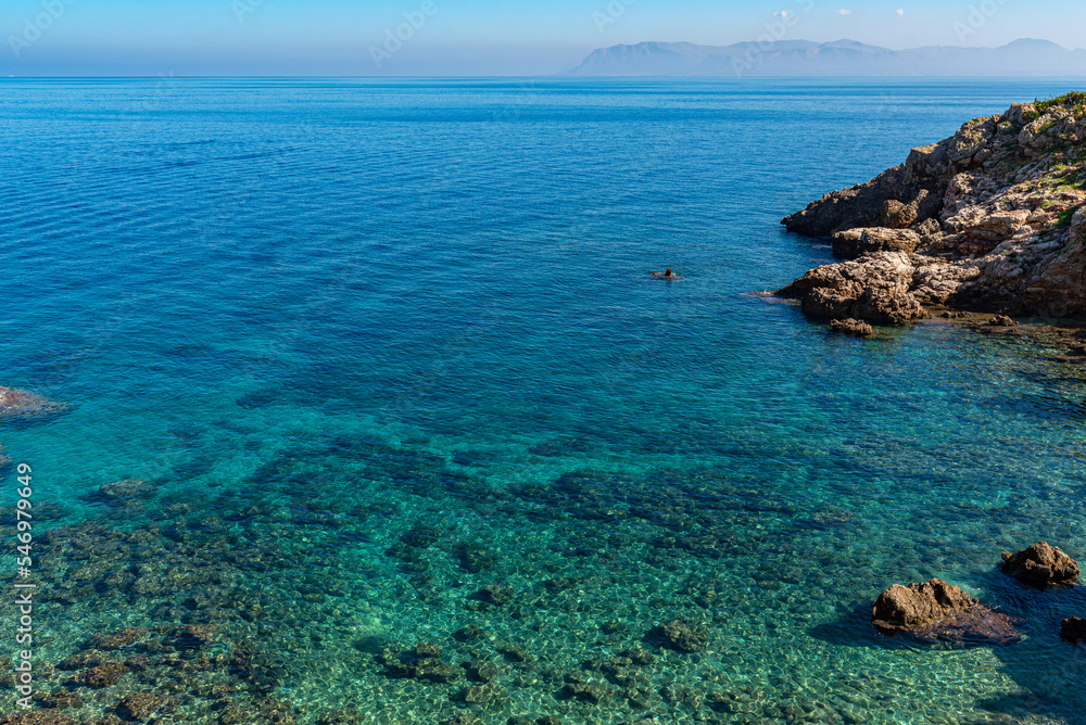 The Disa cove in the nature reserve of the Zingaro National Park in Sicily. The small bay with the pebble beach, offers the possibility to swim in the crystal-clear water of the Mediterranean Sea