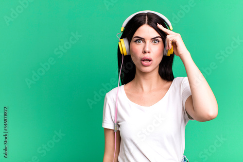 looking surprised, realizing a new thought, idea or concept. listening music qith a headphones photo