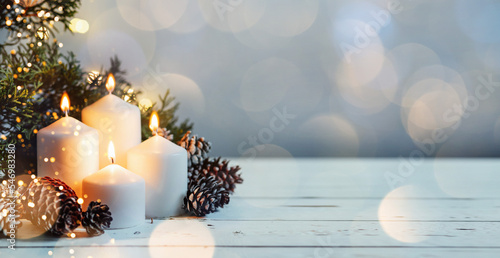 Advent white candles with decor in shiny lights