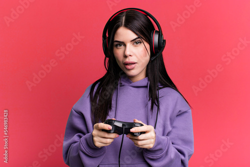 young gamer woman with a headset and a contoller photo