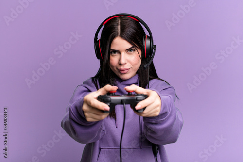 young gamer woman with a headset and a contoller photo