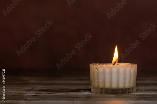 A burning candle in the dark, copy space