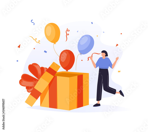 Woman opening gift box and looking at festive confetti thrown out of it. Concept of birthday present, holiday greetings