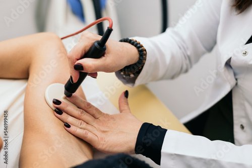 A detail of a beautician applying a radiofrequency treatment to a patient s armpit. Cell stimulation.