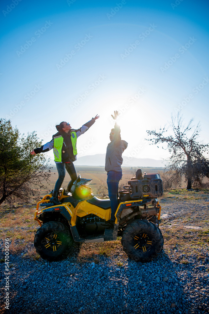 Obraz premium Couple riding a quad bike