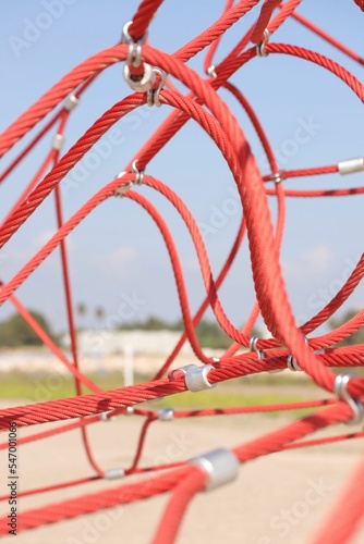 Red rope pyramid playground for climbing on the beach of Pinedo, Valencia photo