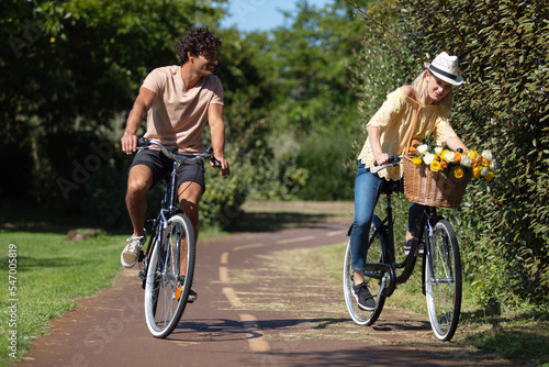 happy couple sharing a bike ride