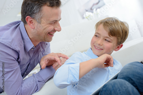 Man walking his fingers up child s back
