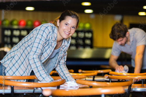 waitress cleaning bar tables