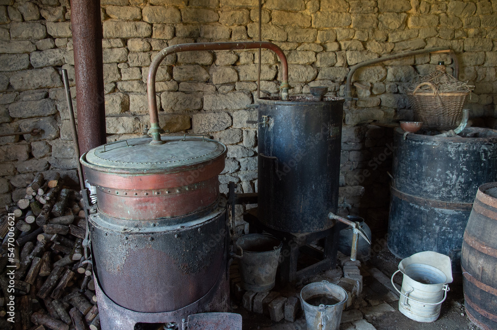 Old still for making alcohol by heating fruit. It is a device intended for the separation of products by heating then cooling (distillation). Old still for making alcohol by heating fruit. It is a device intended for the separation of products by heating then cooling (distillation).