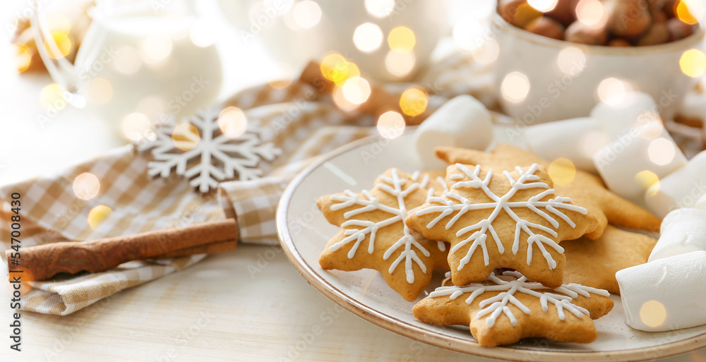 Plate with tasty Christmas cookies and marshmallows on table Plate with tasty Christmas cookies and marshmallows on table