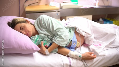 a woman during labor and delivery at the hospital. pregnant woman having contractions in the hospital. birth pains. Pregnant Woman In Labor At Hospital