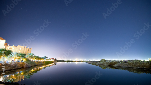 The Royal Commission, Yanbu,  Medina, Saudi Arabia. February 2nd, 2022. The beach and adjacent parks at night, dawn and dusk times. Trees especially palm are shown. Black and colorful skies. Pathways.