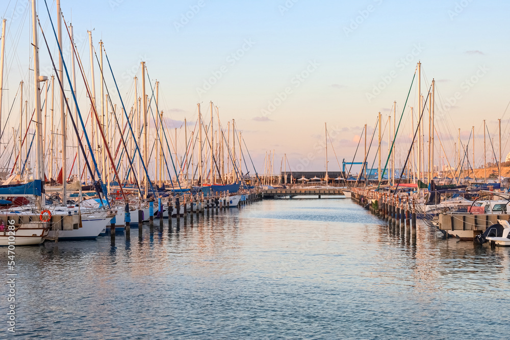 View of beautiful pier with yachts at sunset