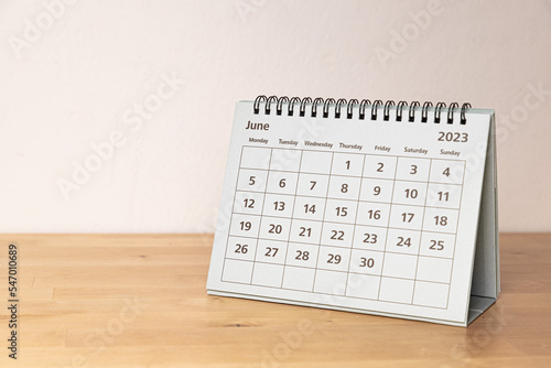 Fototapeta Naklejka Na Ścianę i Meble -  June in 2023 paper calendar on the wooden table - month page