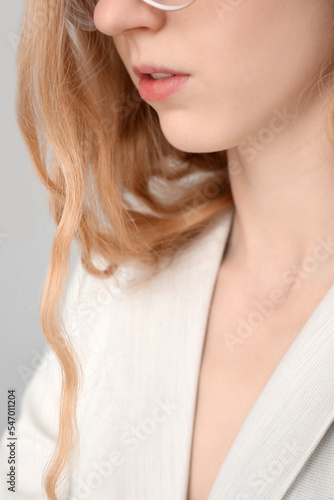 Young woman's face with gla...