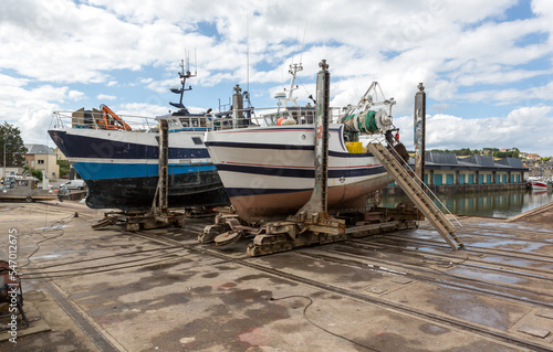 Fishing boats out on dry in dock for maintenance. © Fizzone Photo