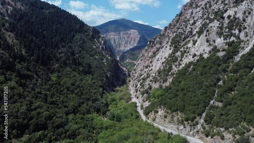 Areal drone footage from Karpenisi area, into the mountains and lake.