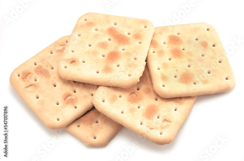 Soda cracker stack closeup, large detailed isolated square crisp whole grain saltine crackers macro closeup, military field ration MRE concept, gentle shadows, perforations, saltines flat lay detail
