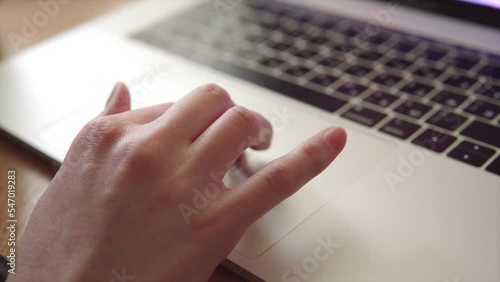 Freelancer woman uses modern laptop touchpad or trackpad with her hand. photo