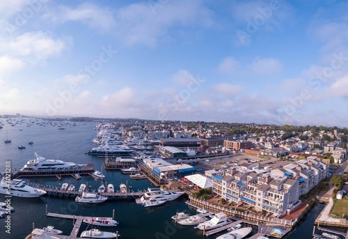 Aerial shot of the Newport Harbor in Rhode Island with ducked boats and a cloudscape photo