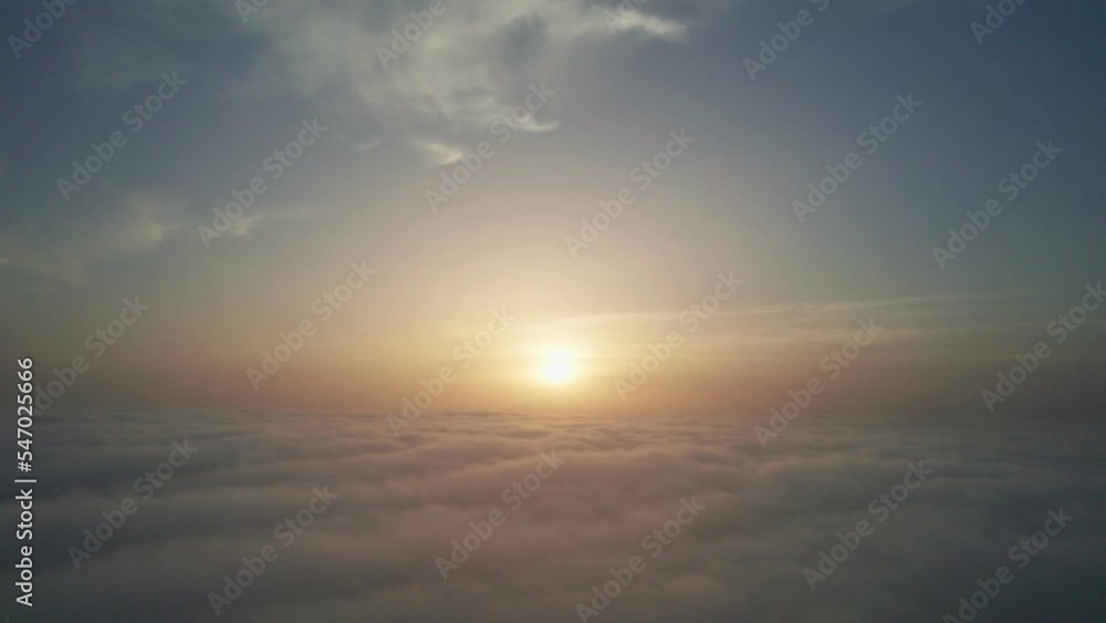 View from the cockpit of an airplane above the clouds at sunrise. View from the cockpit of an airplane above the clouds at sunrise.