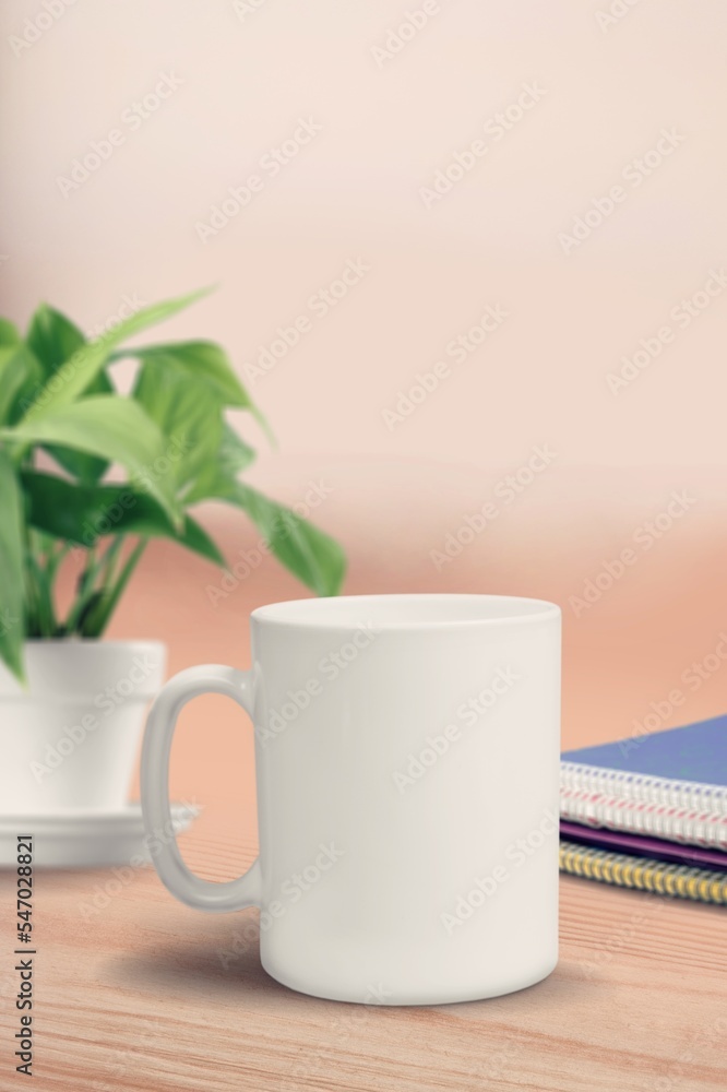 Blank white mug or cup on office desk