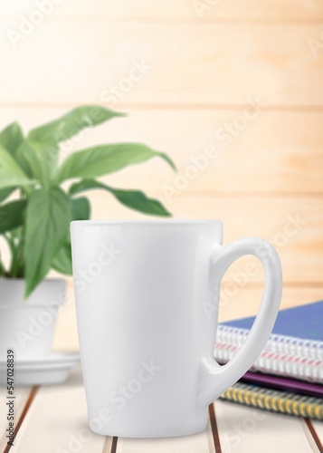 Blank white mug or cup on office desk