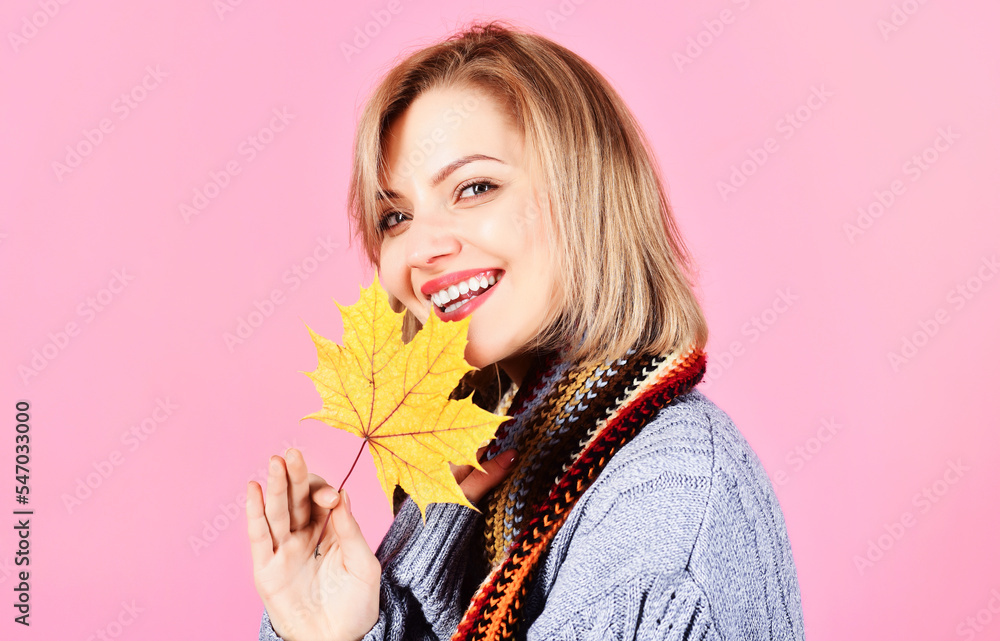 Autumn girl in warm clothes with yellow leaves. Beautiful woman in knitted sweater and scarf. Autumn girl in warm clothes with yellow leaves. Beautiful woman in knitted sweater and scarf.
