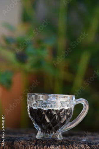 coffee cup on rustic wooden base with blurred background
