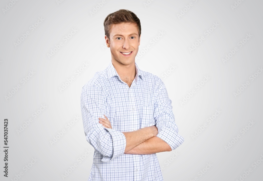 Serious young man posing on the background Serious young man posing on the background