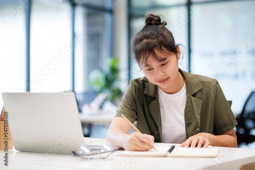 Young asian business woman or student working online on computer laptop.