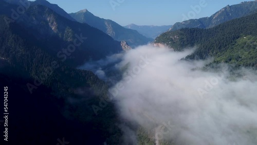 Areal drone footage from Karpenisi area, into the mountains and lake.