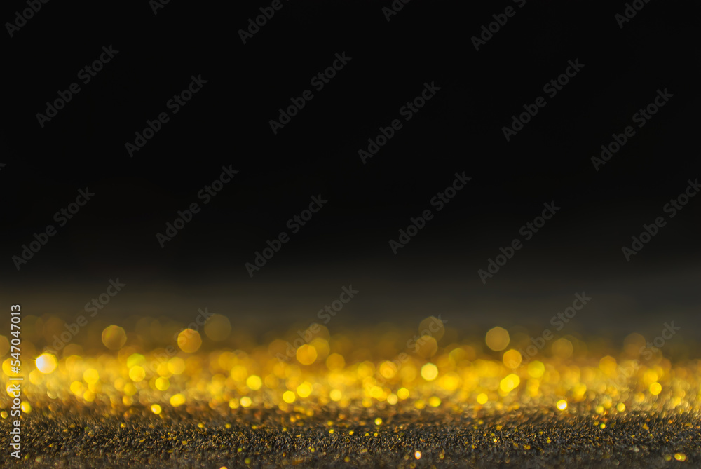 Holiday illumination and decoration concept. abstract glitter lights gold christmas  bokeh lights  dark black background defocused banner. new year celebration.