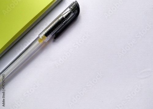 Paper background copy space with pen, yellow book and note