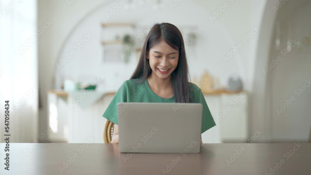 Funny euphoric young asian woman celebrating winning or getting ecommerce shopping offer on computer laptop. Excited happy girl winner looking at notebook celebrating success Funny euphoric young asian woman celebrating winning or getting ecommerce shopping offer on computer laptop. Excited happy girl winner looking at notebook celebrating success
