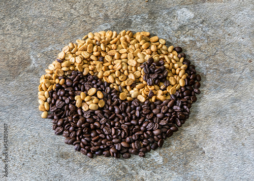 Yin and Yang symbols arranged in coffee beans against an old plaster background. © Boonlert