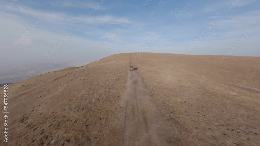FPV sports drone follow shot SUV automobile race rally offroad riding desert mountain adventure sand splash. Aerial view cinematic hilly valley dirt road transportation extreme tourism exploration 4k FPV sports drone follow shot SUV automobile race rally offroad riding desert mountain adventure sand splash. Aerial view cinematic hilly valley dirt road transportation extreme tourism exploration 4k
